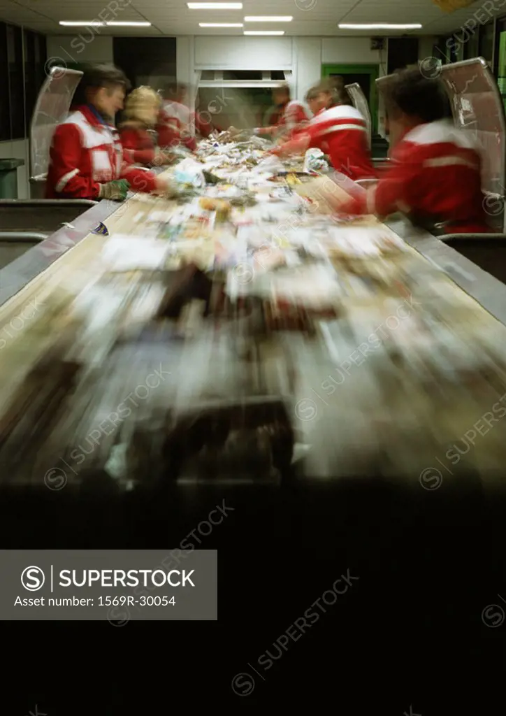 People working in assembly line, blurred