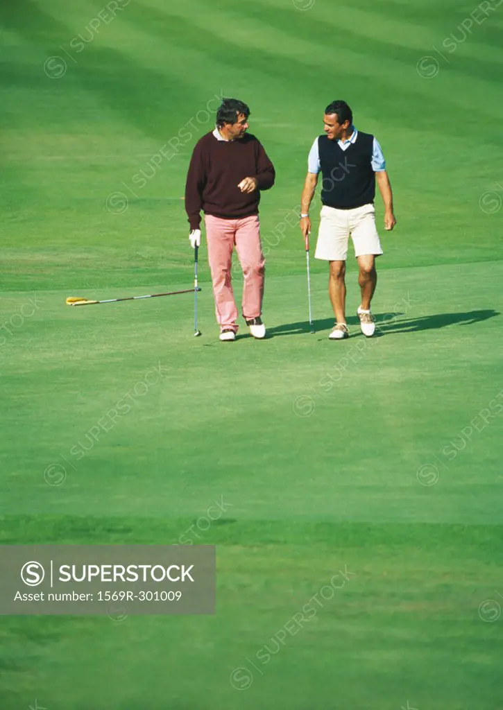 Two golfers walking on golf course