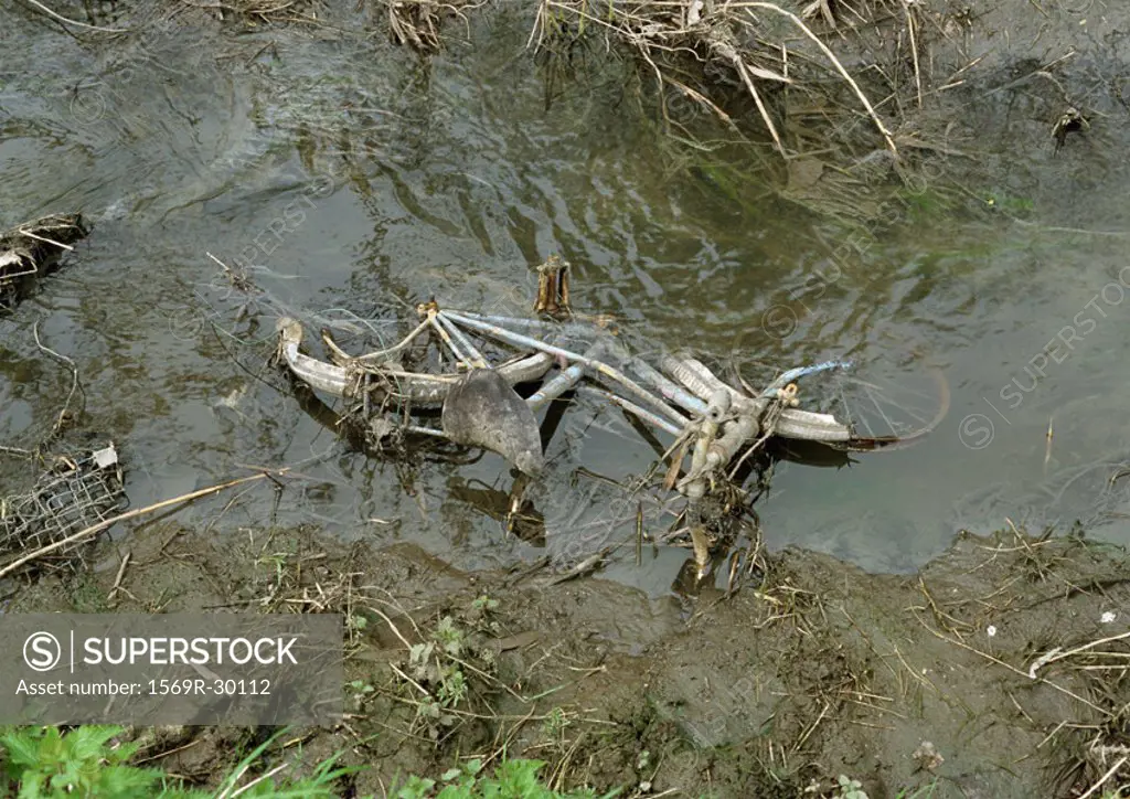 Bicycle submerged in mud and water