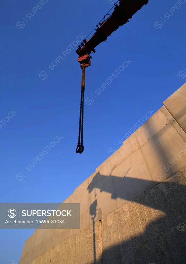 Crane and shadow on wall, low angle view