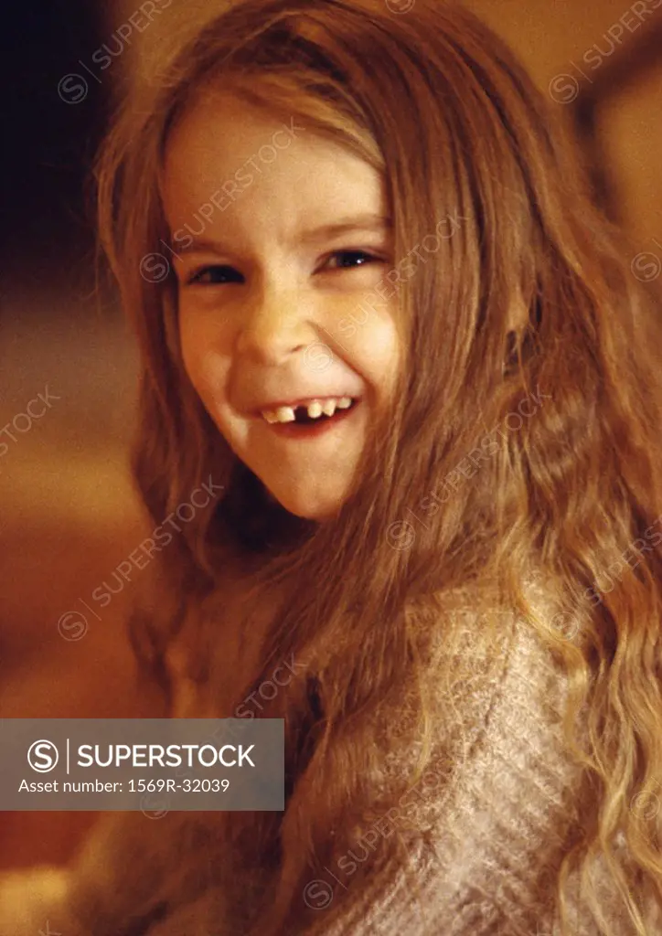Little girl smiling with missing tooth