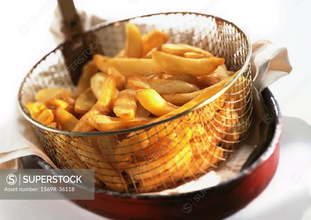 French fries in frying basket, close-up