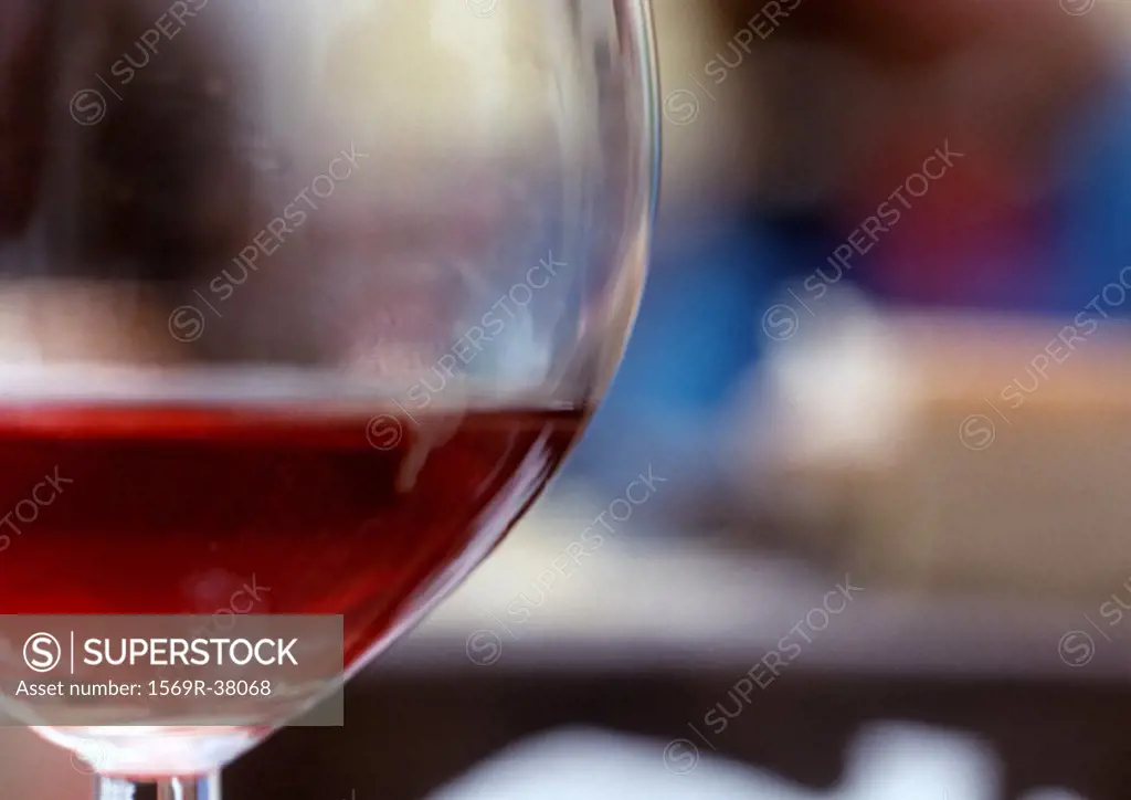 Wine glass containing red wine, extreme close-up