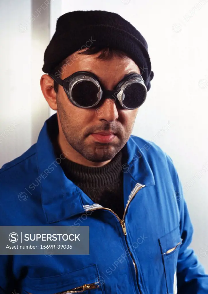 Man in coveralls wearing protective glasses, portrait