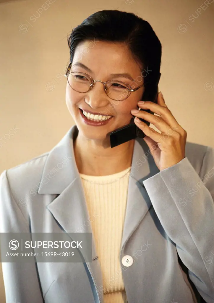 Businesswoman using telephone, portrait