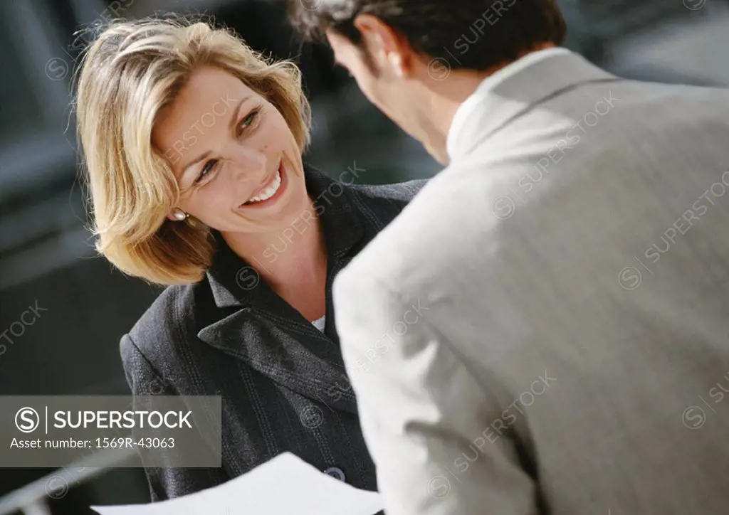 Businessman and businesswoman face to face, close-up