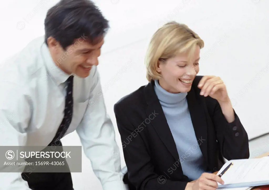 Businessman and businesswoman laughing