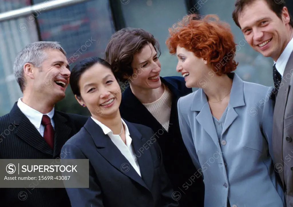 Group of business people standing together, smiling