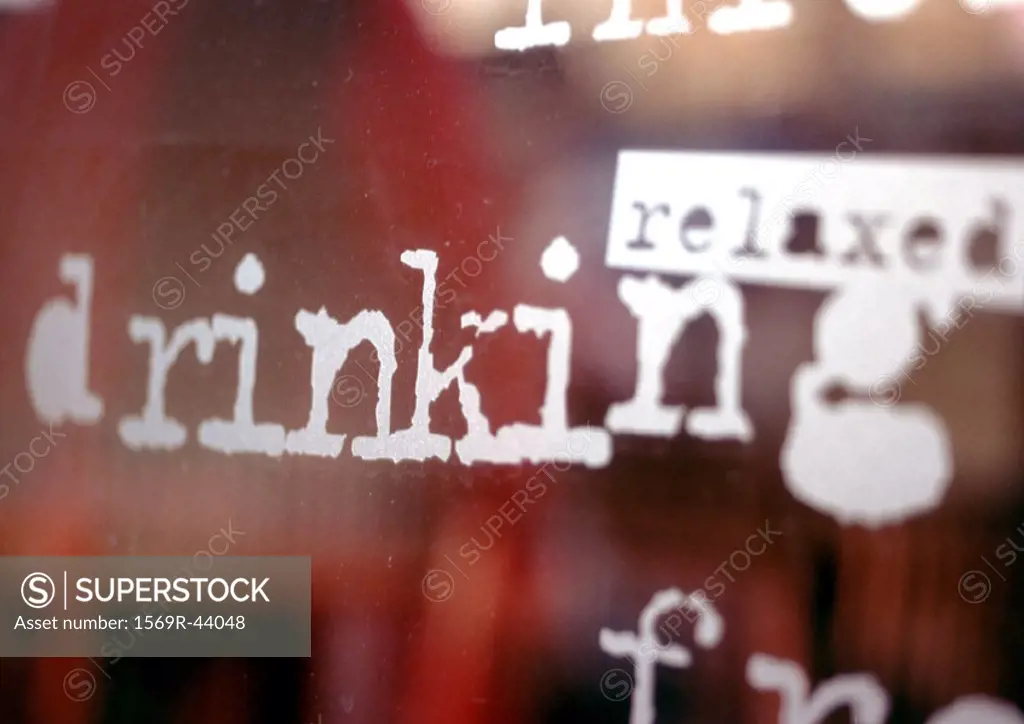 ´Relaxed, drinking´ text on window, close-up