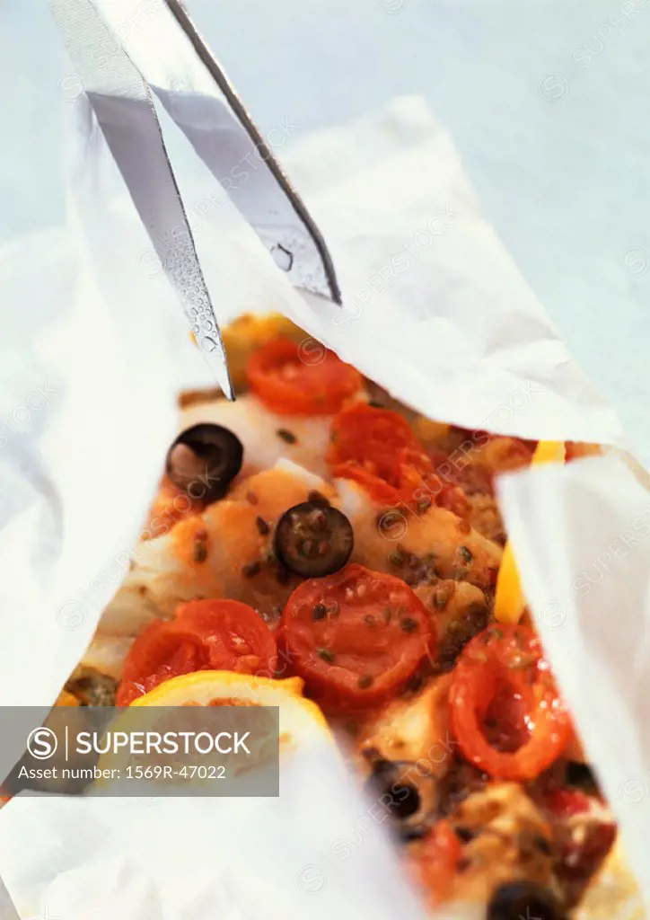 Fish, olives and tomatoes in cooking paper