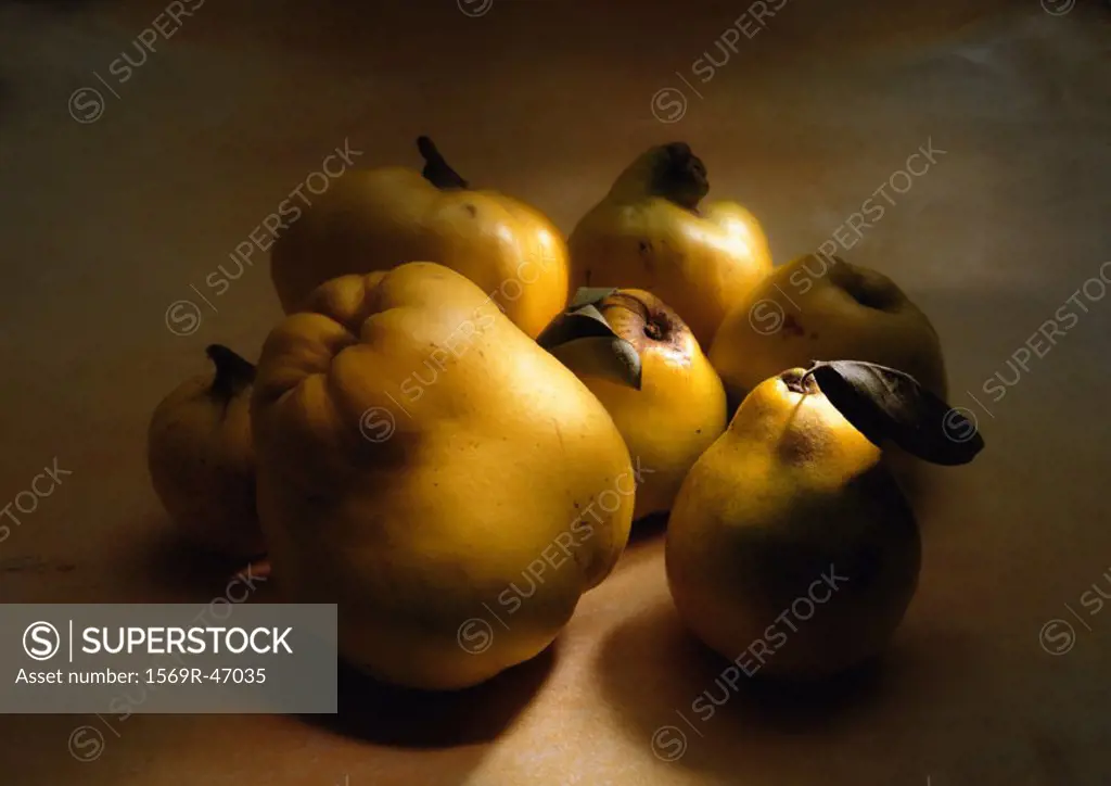 Group of quinces of different sizes in shadow, close-up