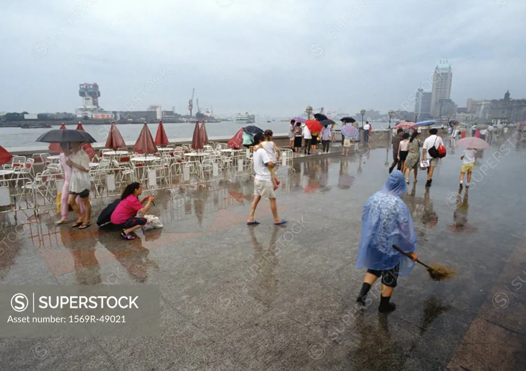 China, Shanghai, The Bund, people walking in rain