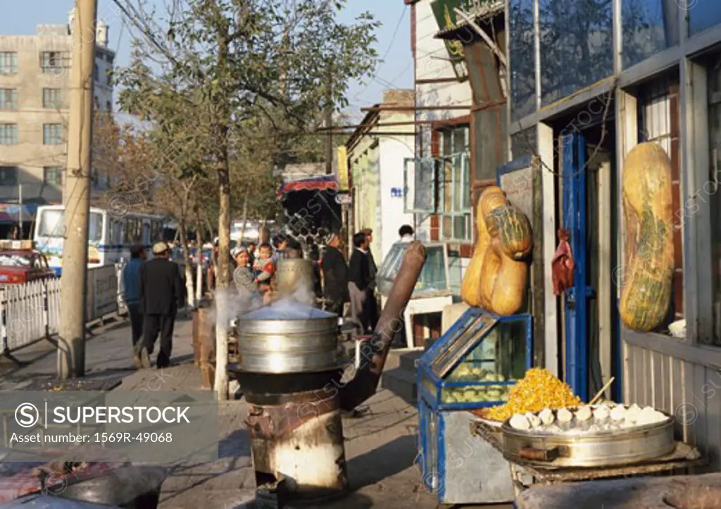 China, Xinjiang, Urumqi, food being sold on sidewalk
