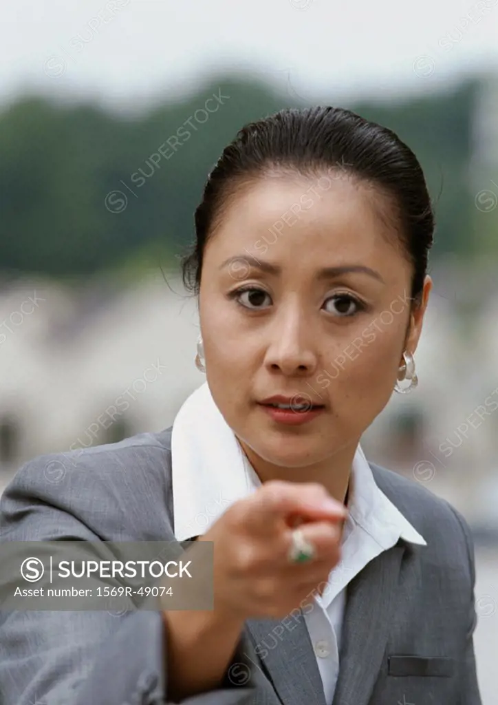 Woman pointing finger at camera, portrait