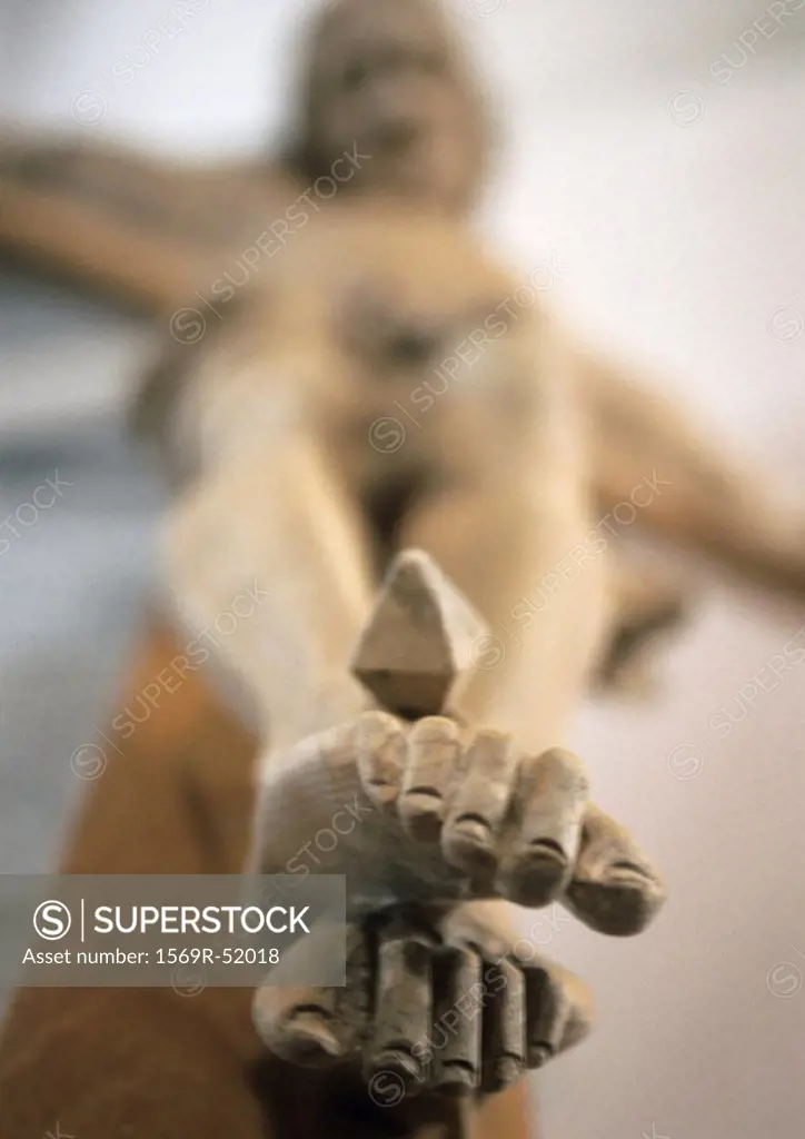 Statue of the Crucifixion, focus on feet, low angle view
