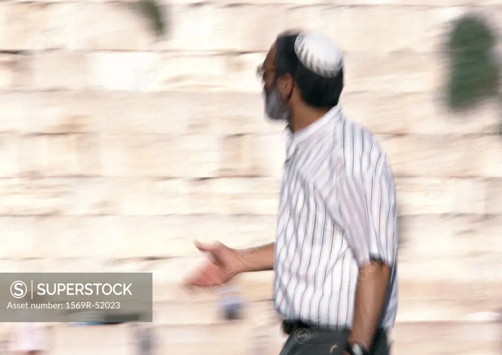 Israel, Jerusalem, mature man wearing kippa near Wailing Wall, blurred