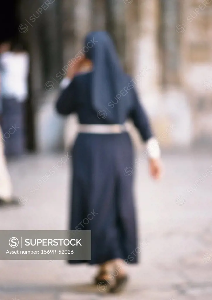 Nun, rear view, blurred