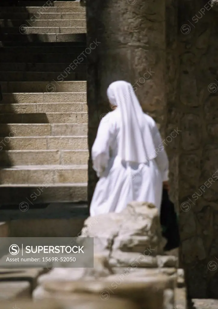 Israel, Jerusalem, nun by stairs, rear view