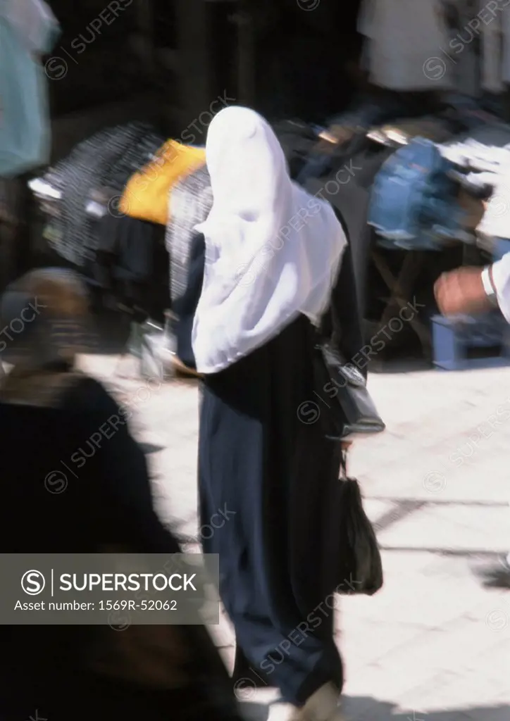 Israel, Jerusalem, Muslim woman in street, rear view
