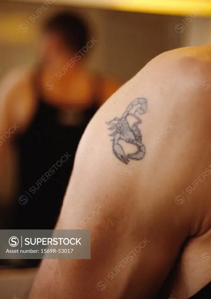 Scorpion tattoo on man´s shoulder, close-up