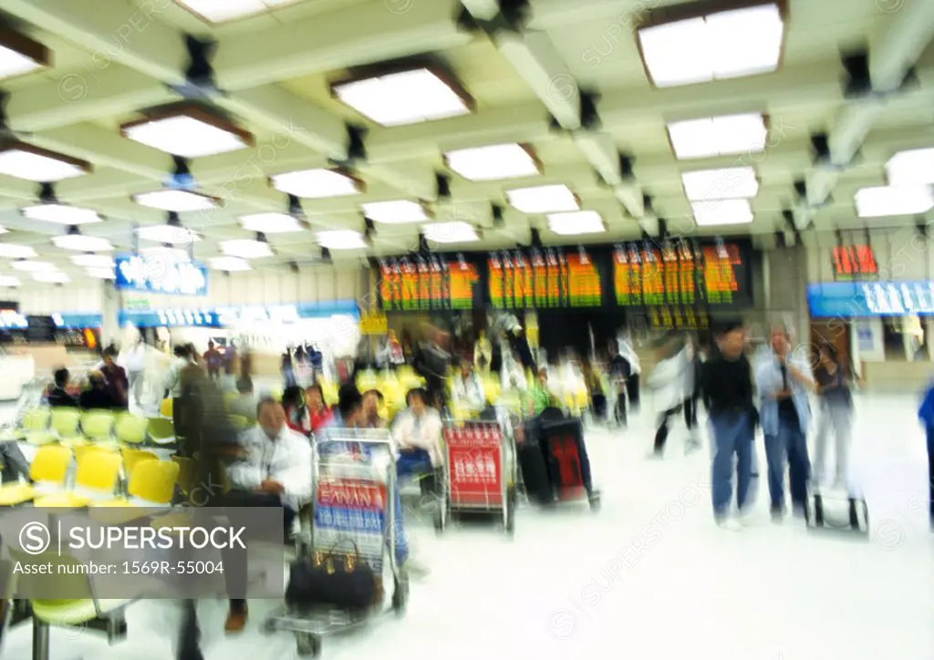 People in airport terminal, blurred