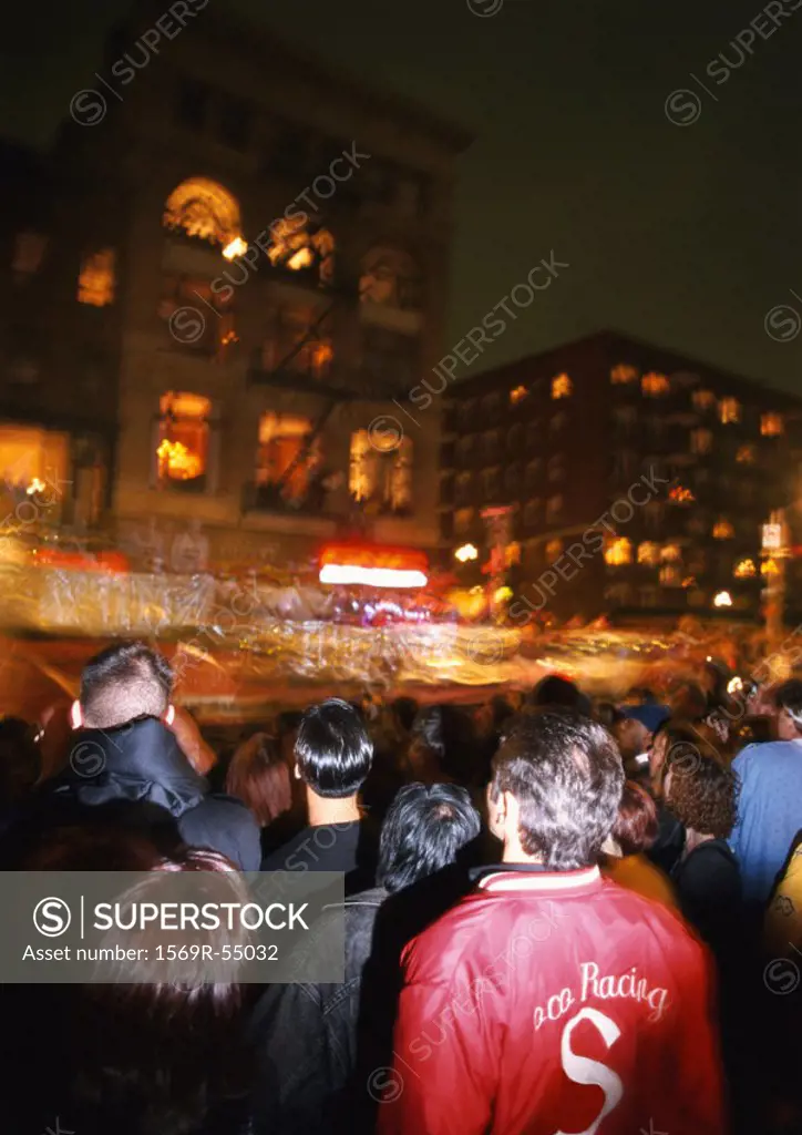 Crowd in street at night, blurred motion