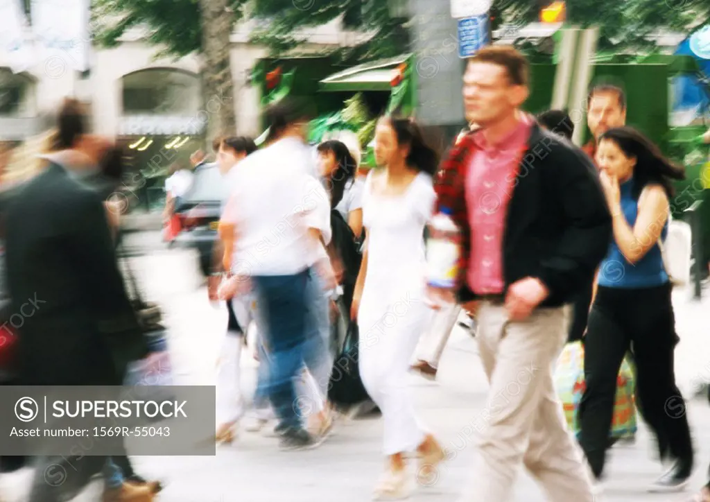 People walking in street, blurred