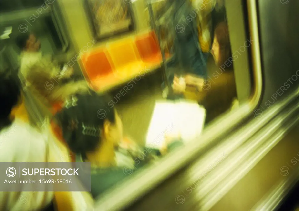 People in subway, viewed from outside, blurred