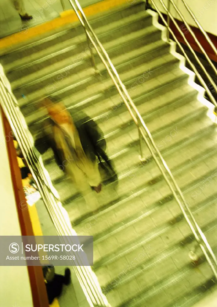 Man on stairs, high angle view, blurred
