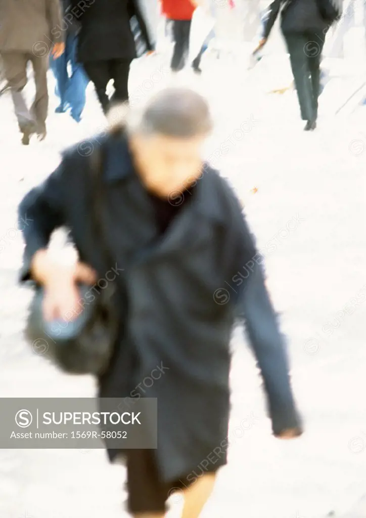 Mature woman walking, blurred