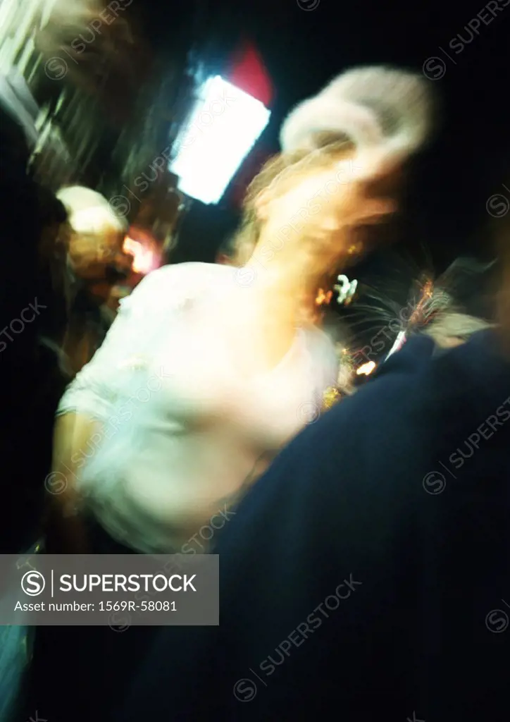 People in street at night, blurred