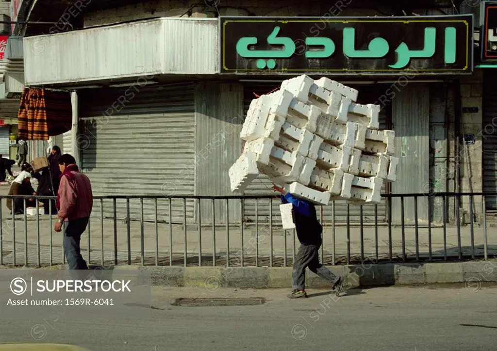 Jordan, man carrying styrofoam blocks