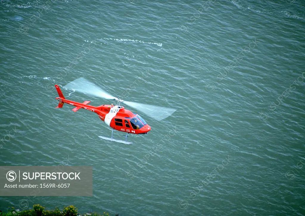 Helicopter flying over water