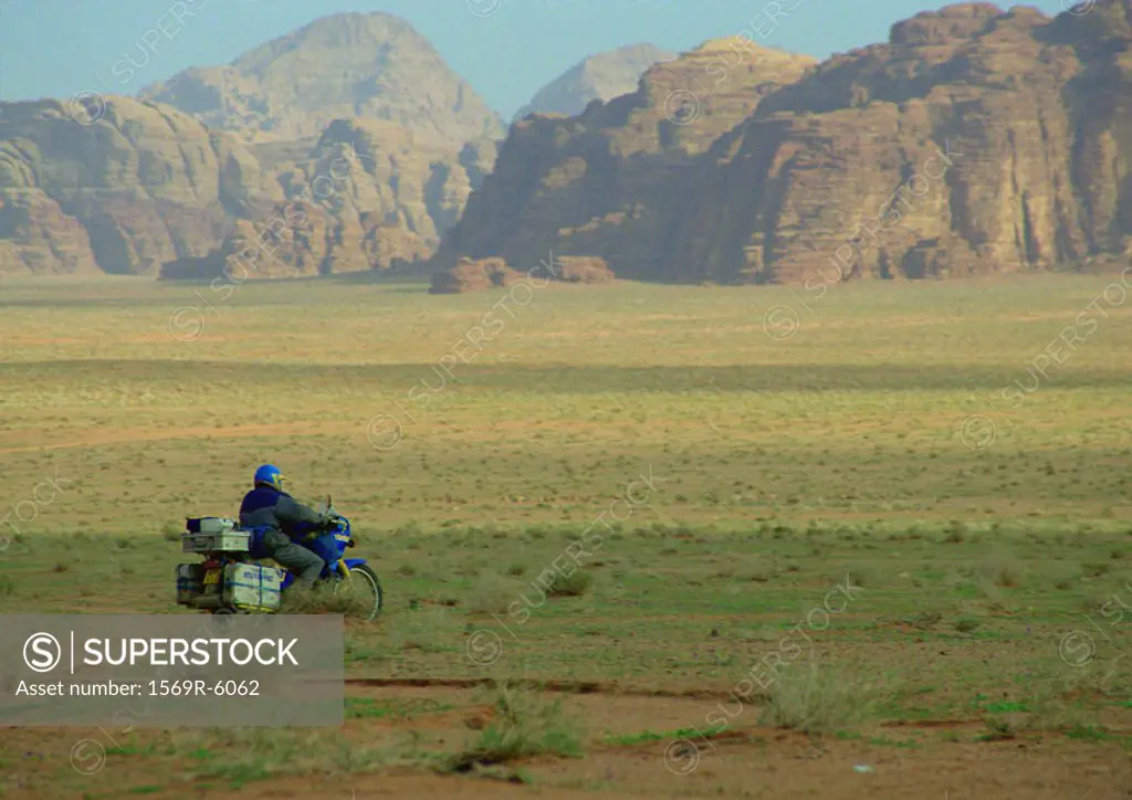 Jordan, motorcyclist riding through mountainous region