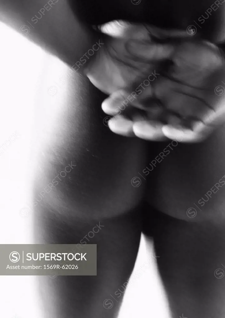 Man´s bare buttocks and hands, close up, black and white