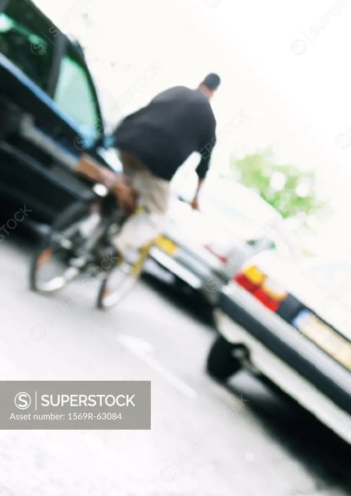 Cyclist and cars, tilted, blurred