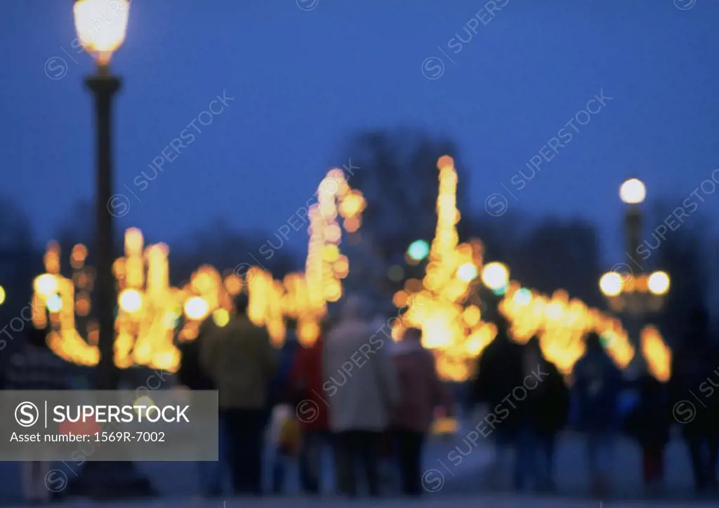 France, Paris, people and illuminations at night, blurred
