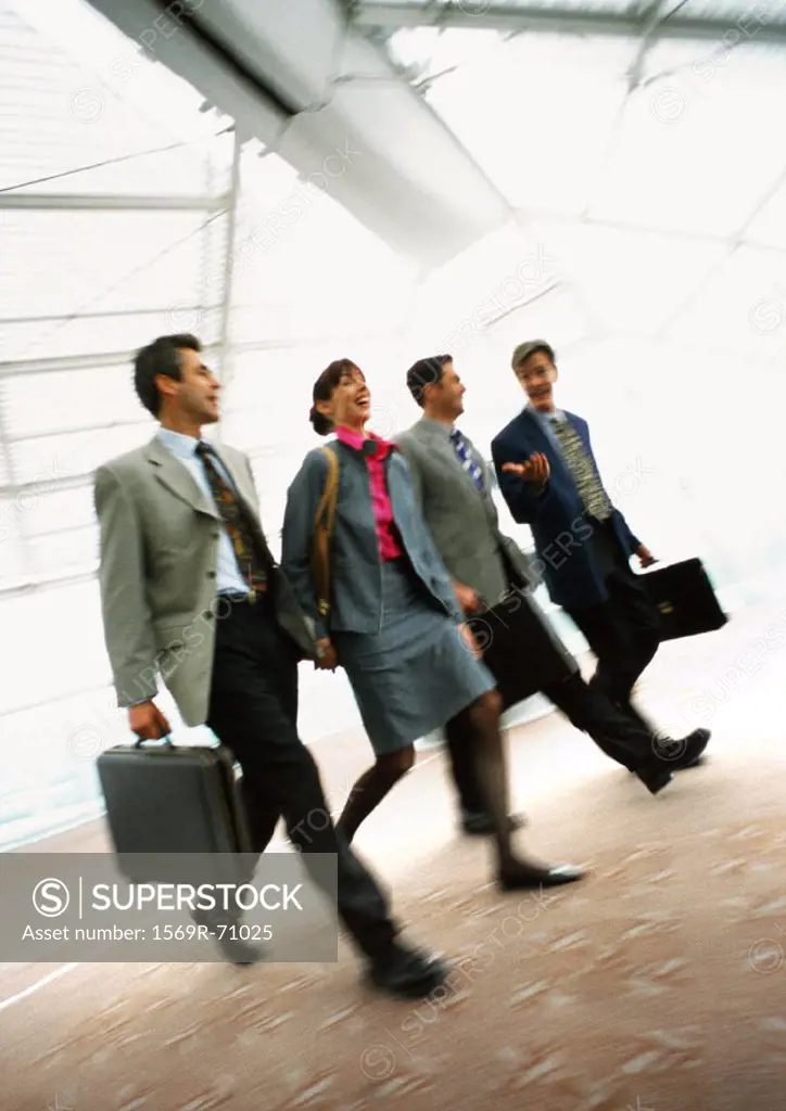 Group of business people walking together indoors, blurred