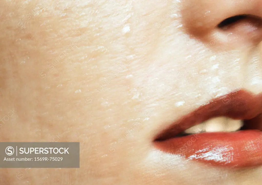 Woman wearing red lipstick, close up of open mouth and wet skin, cropped, blurred