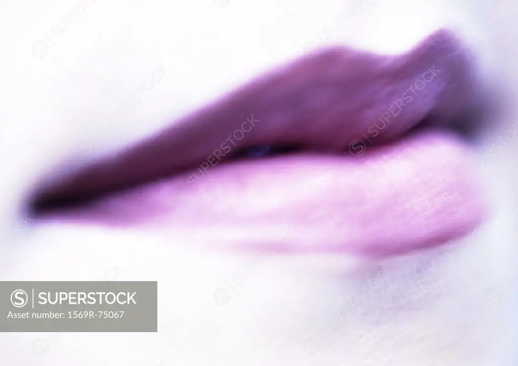 Woman wearing purple lipstick, extreme close up, blurred