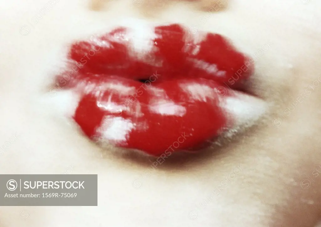 Woman´s lips painted white and red, close up, blurred