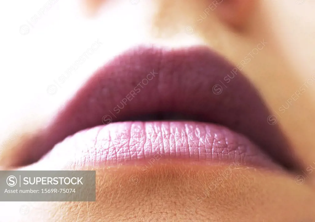 Woman wearing lipstick, close up of mouth, low angle view