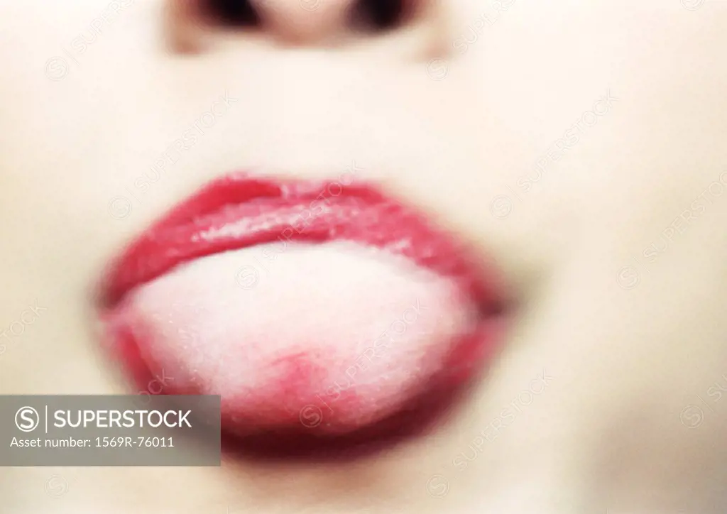 Close up of woman´s mouth with tongue sticking out, blurry