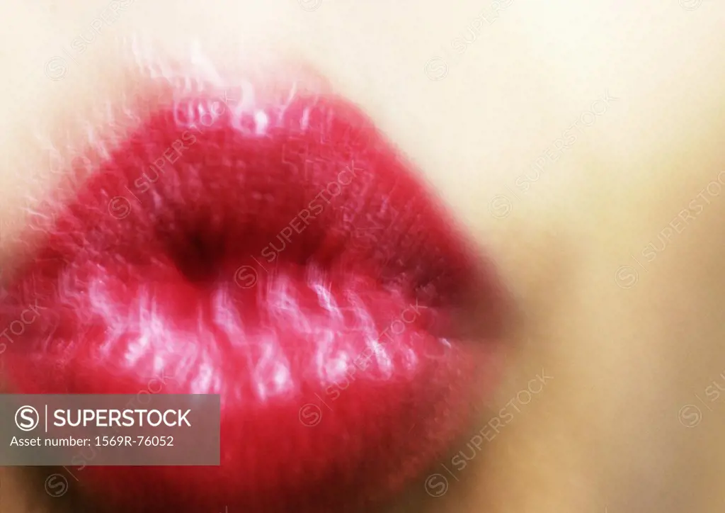 Close up of woman´s mouth puckering, blurry