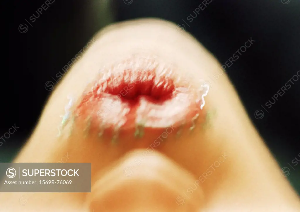 Close up of woman´s mouth puckering with adornments, blurry, upside down