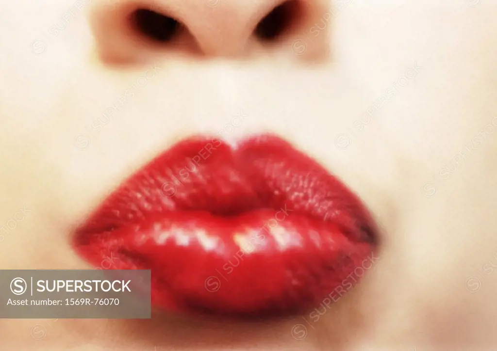 Close up of woman´s mouth with red lipstick, blurry