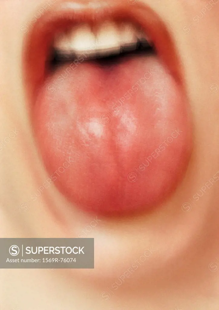 Close up of woman´s mouth with tongue sticking out, blurry