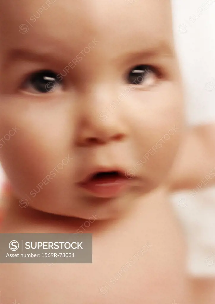 Baby looking at camera, close-up, blurred
