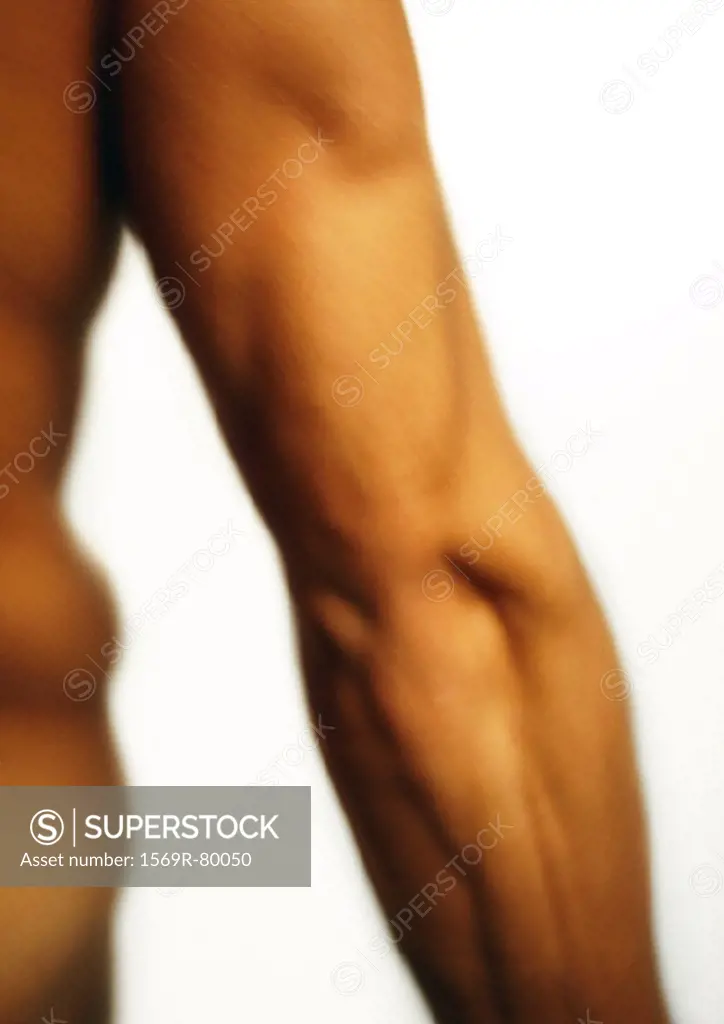 Man´s flexed triceps, blurred, close-up