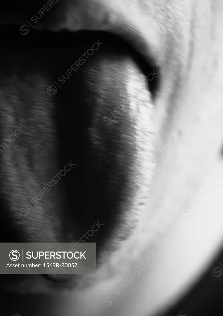 Man sticking tongue out, blurred, close-up, black and white